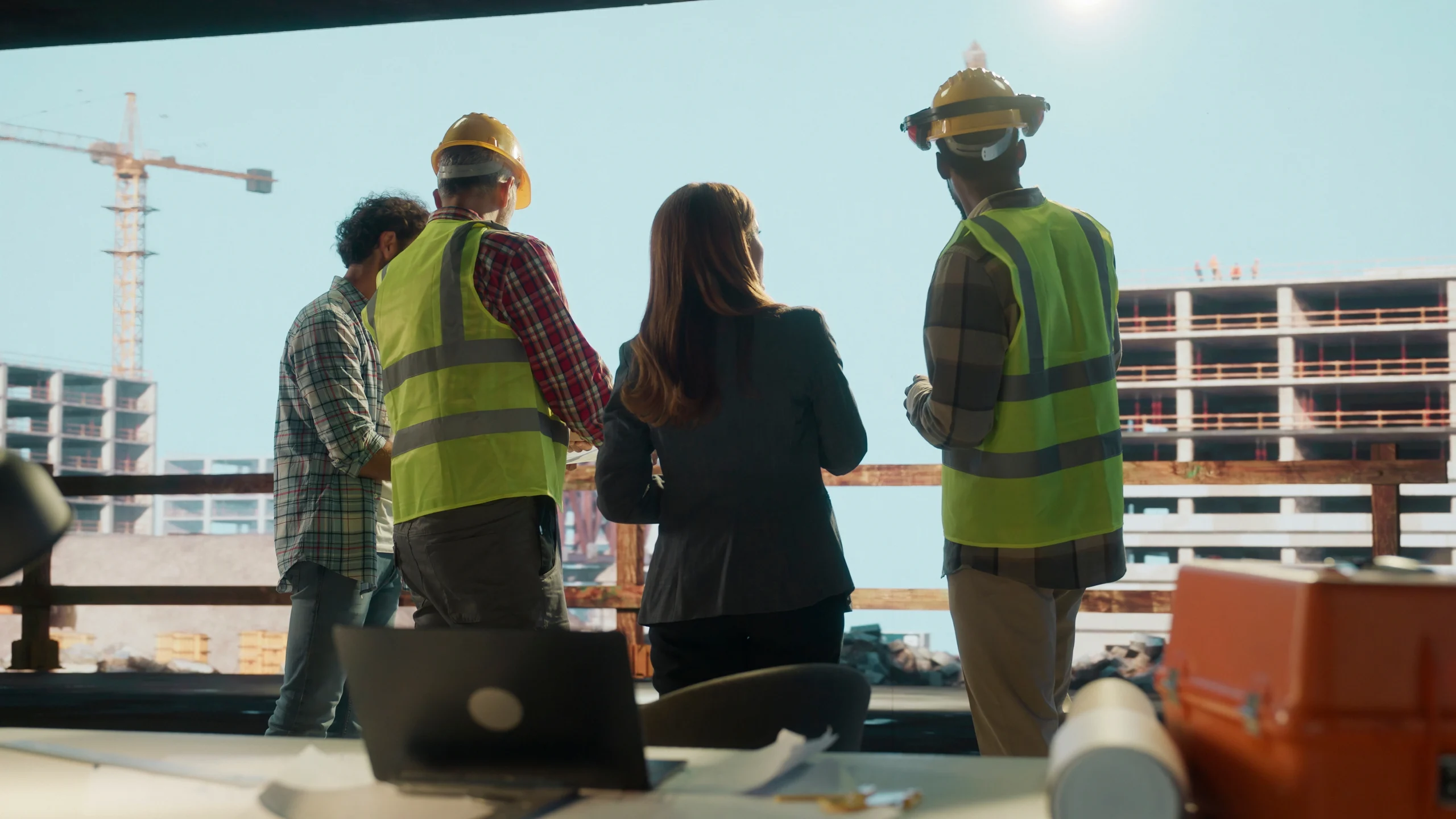 Construction Team Engineers Reviewing Building Site Scaled
