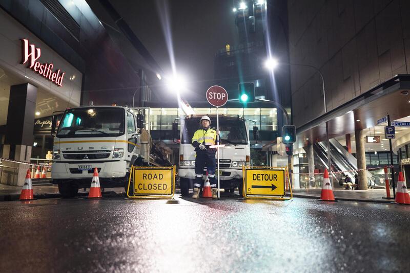 SSTC site security and traffic management road closure with detour signs outside commercial building in Sydney